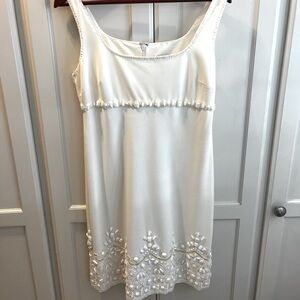 White elegant dress with beaded detail. Never worn with price tag still on.